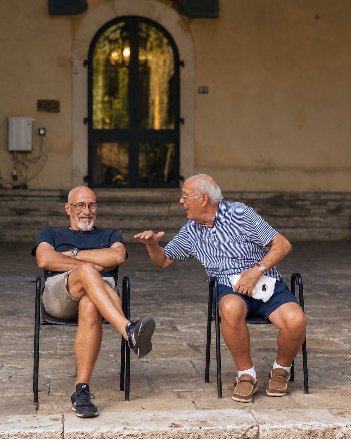 Two elders in warm conversation outside