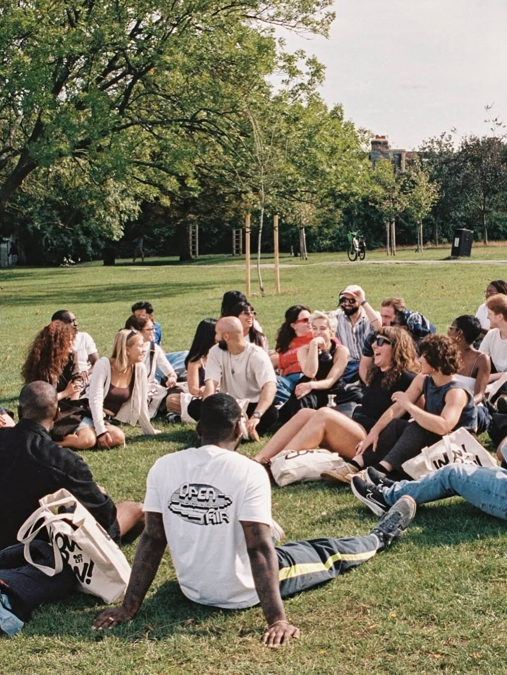 Community members gathered on a park lawn, laughing